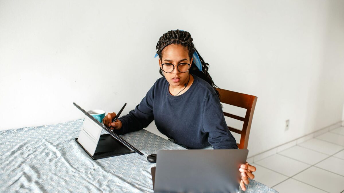 woman working on laptop and tablet